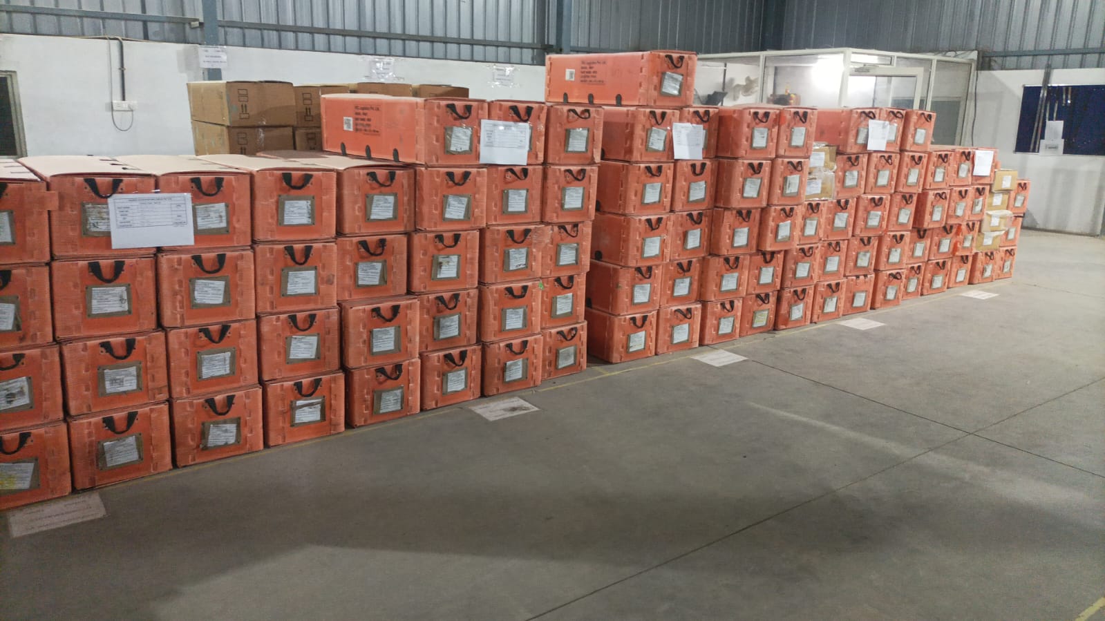 Original PCL photograph of returnable packaging staged in warehouse rows